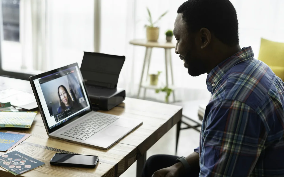 Remote employee on a video call from his home office